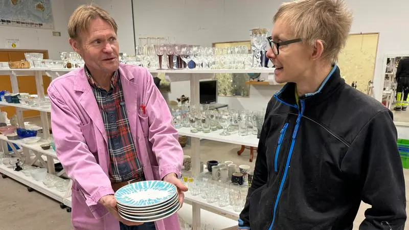 Två deltagare visar Överskottsförrådet.