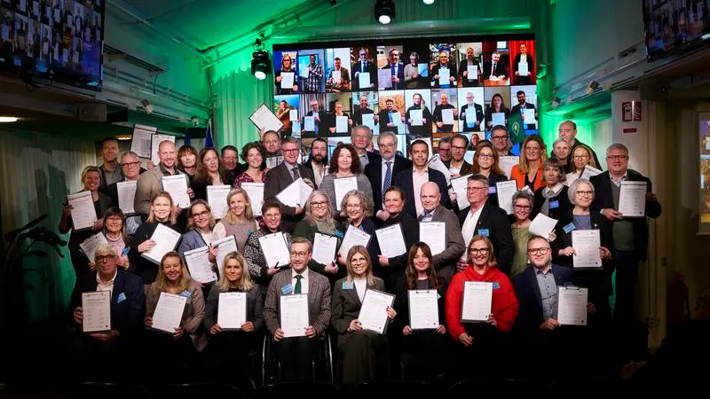 En grupp människor håller upp påskrivet kontrakt.