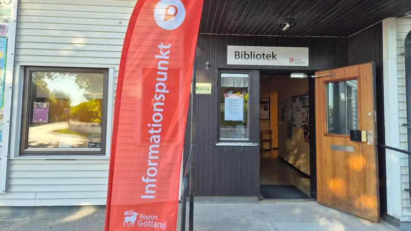 Biblioteksentré med röd flagga med texten "informationspunkt" på.