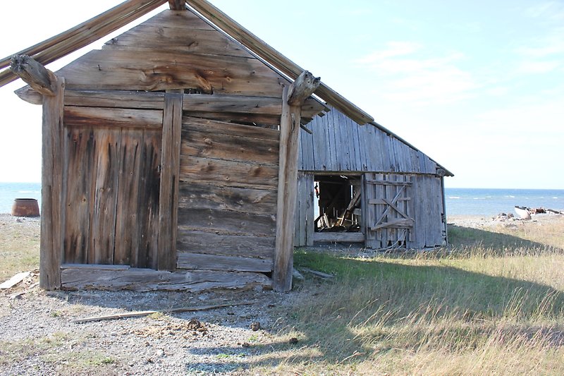 Gammal fiskebod nära havet.